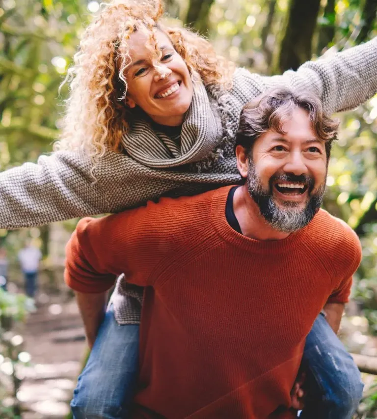 Senior couple walking hand in hand on a gravel path